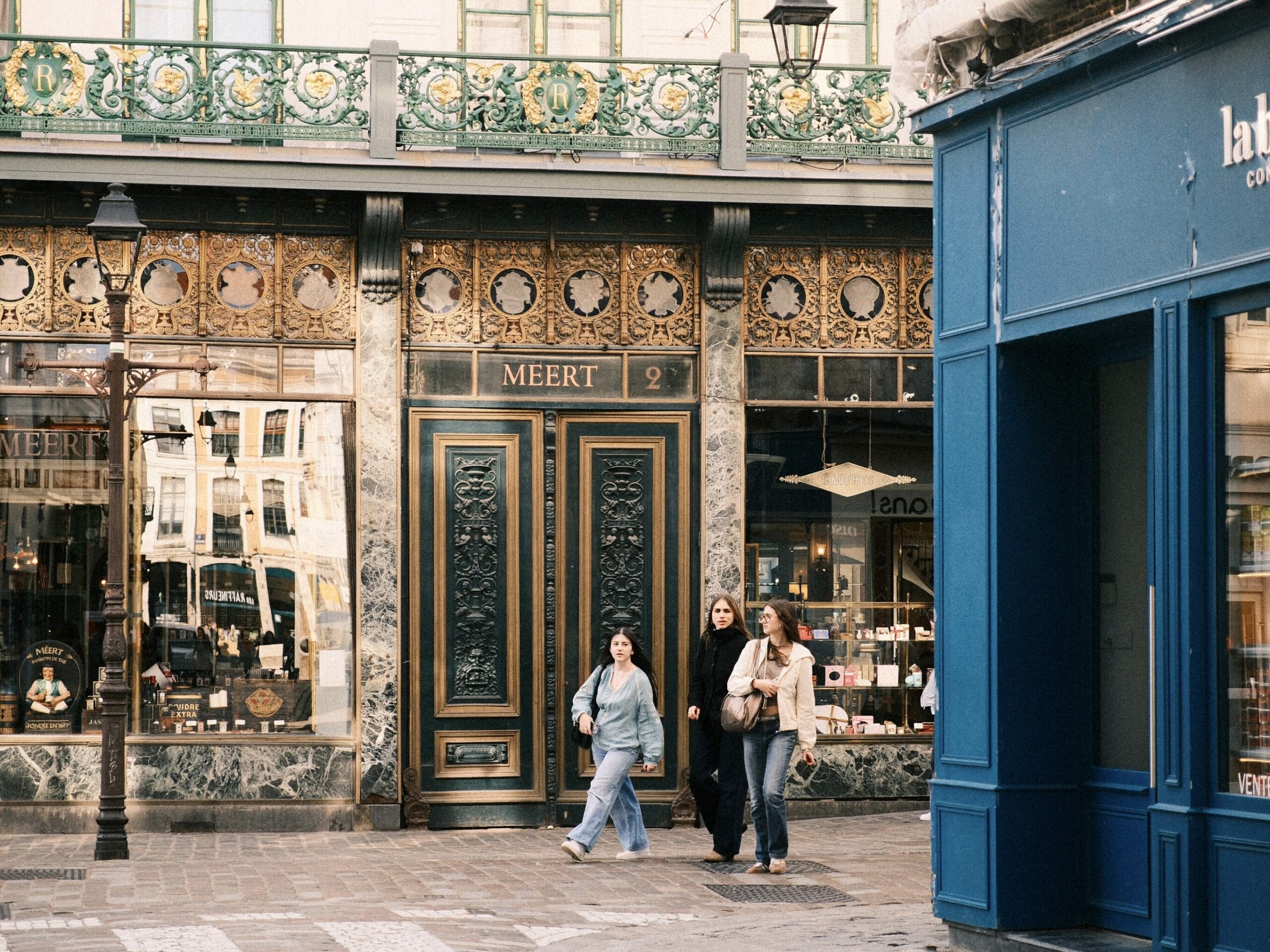 Historic Merit pastry shop in Old Lille, France, with people walking past